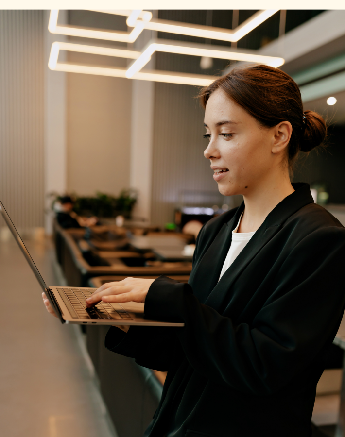 A professional working on a laptop in a modern office