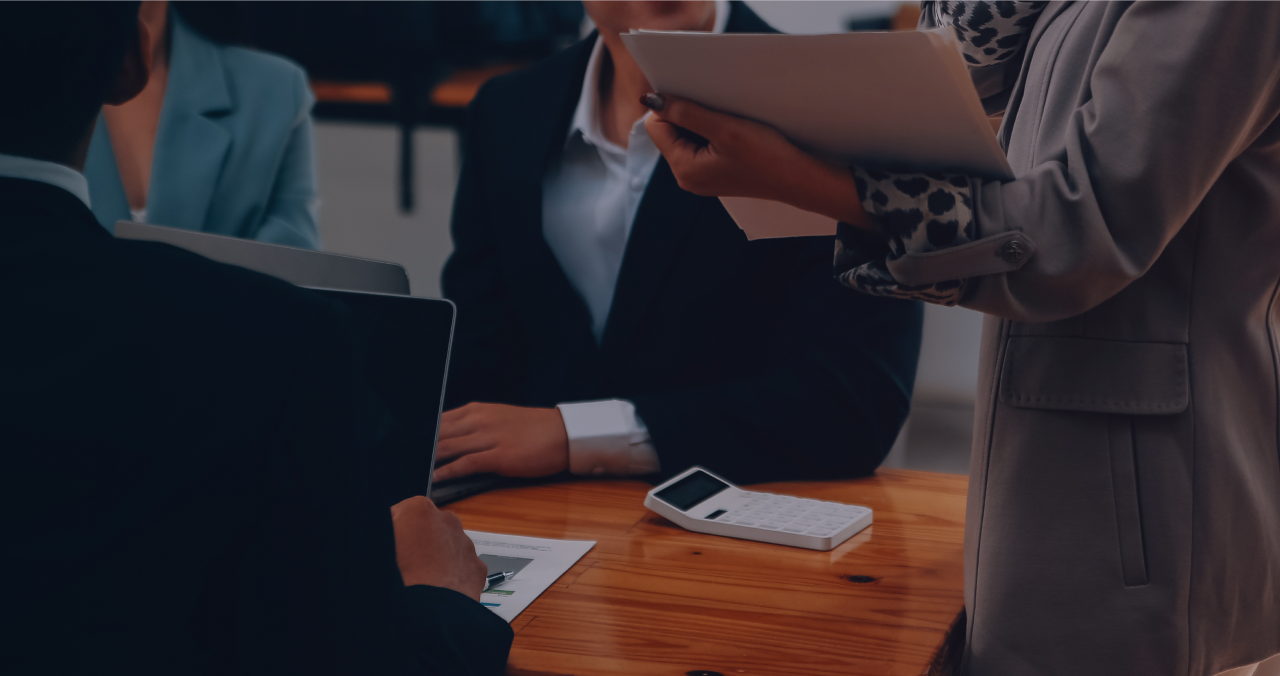 Insurance professionals reviewing documents together around a table