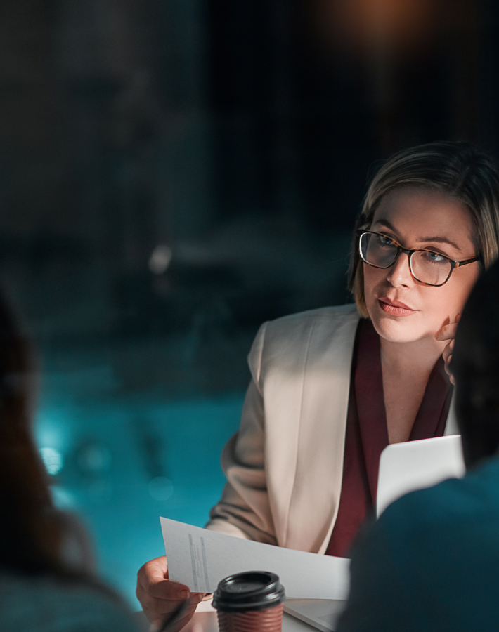 An insurance specialist discussing documents with colleagues